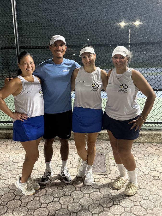 Coach Liam with three players in matching team tanks