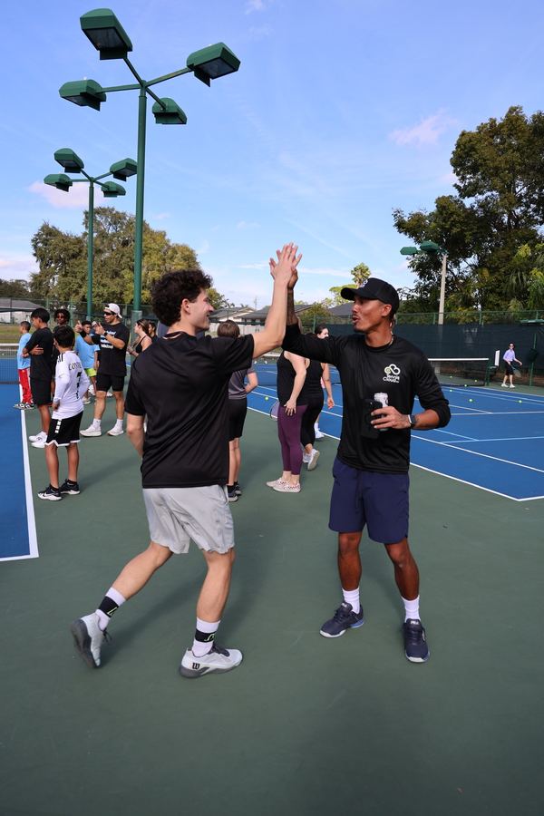 Coach Liam high-fiving a player mid-session