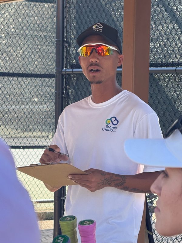 Coach Liam with a clipboard, running an event