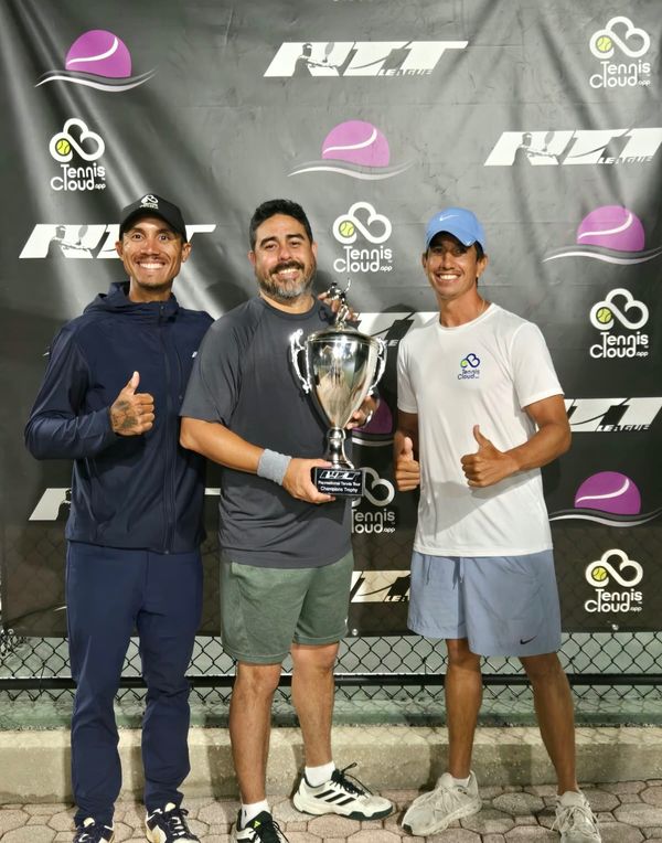 Coach Liam (left) celebrating an RTT League champion and his trophy