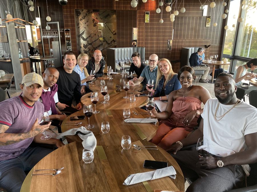 Players gathered around a long table at a team dinner